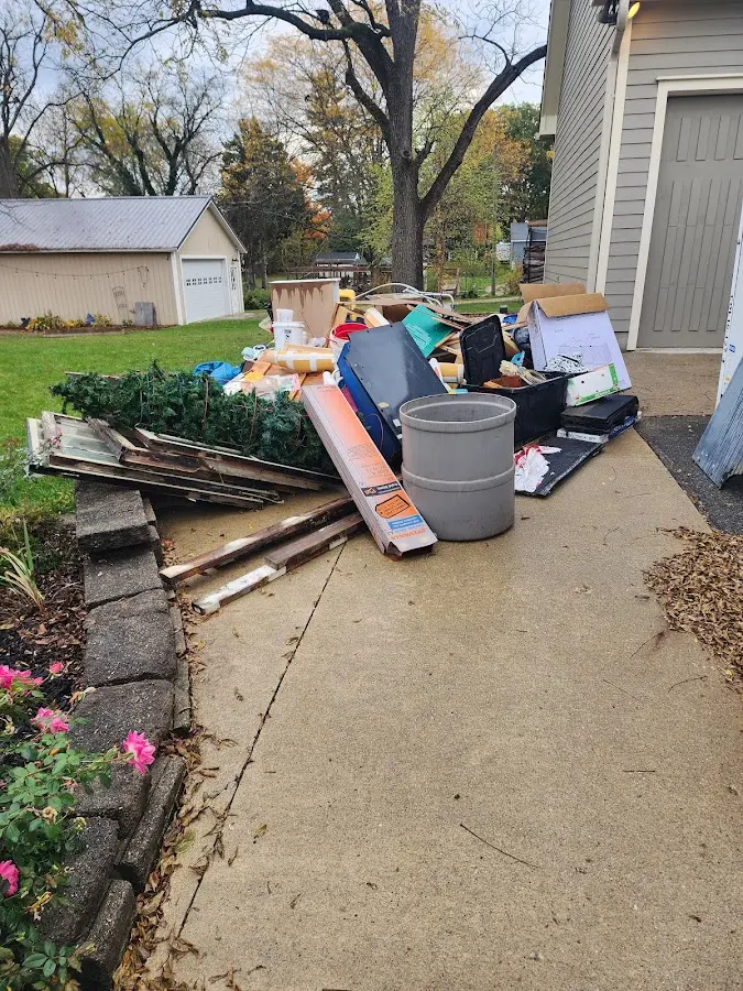 Dumpster being loaded with debris for Estate Cleanout Dumpster Rental in Anadarko